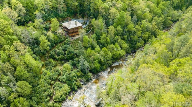 birds eye view of property with a wooded view