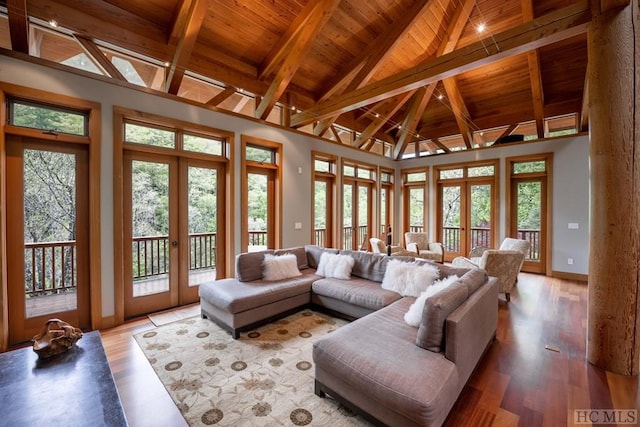 living room with baseboards, wooden ceiling, french doors, light wood-style floors, and beam ceiling