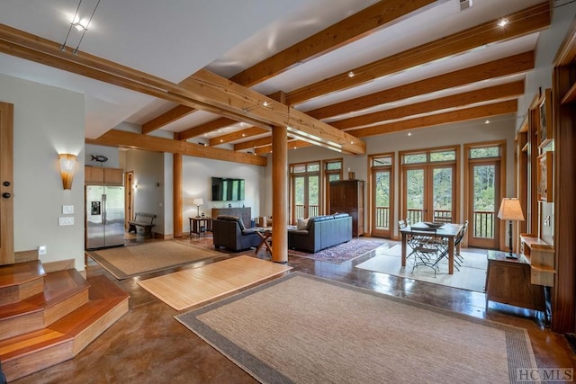 living room featuring beam ceiling and french doors