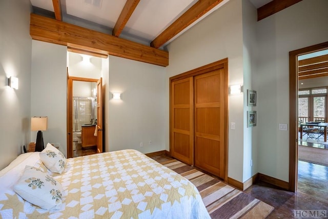 bedroom featuring a closet, baseboards, and beamed ceiling