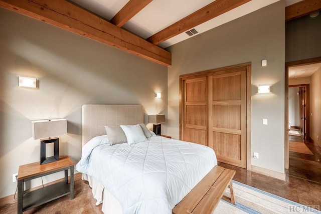 bedroom with beamed ceiling, visible vents, and baseboards