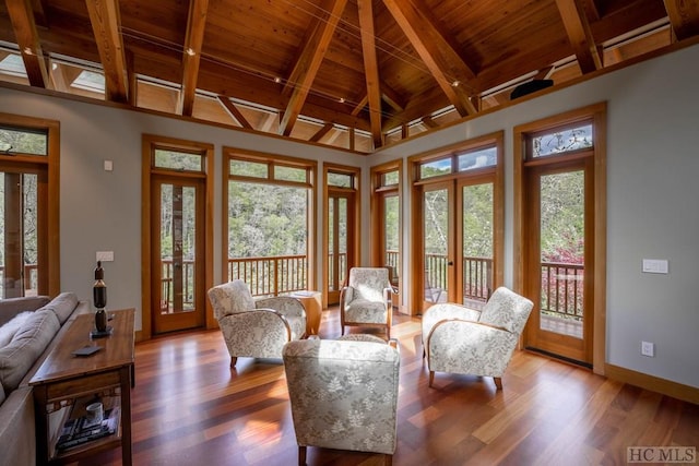 sunroom featuring wood ceiling, vaulted ceiling with beams, plenty of natural light, and french doors