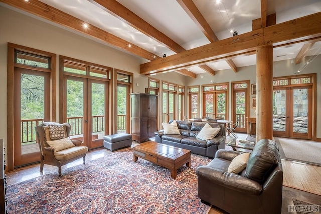 living area featuring french doors and beamed ceiling