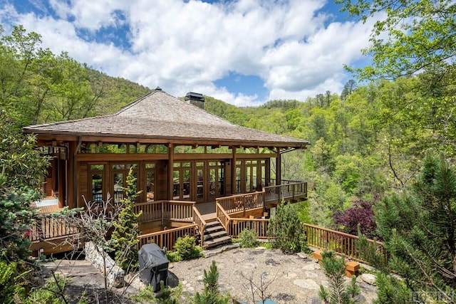 wooden deck featuring a forest view