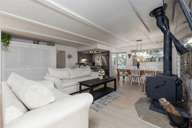 142 Wheatstone Dr, Glenville, NC 28736 - living room with a wood stove, beamed ceiling, and light wood-type flooring