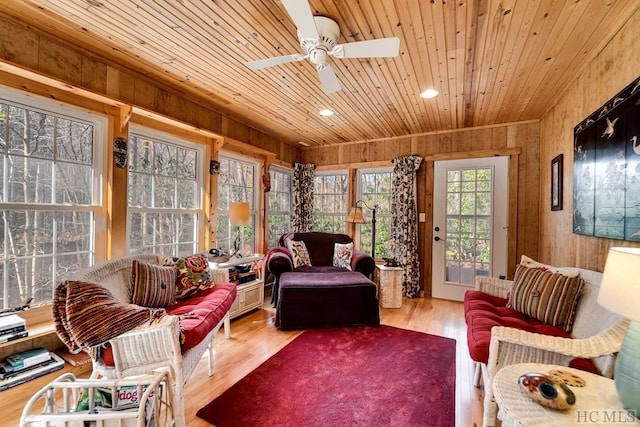 sunroom featuring ceiling fan and wooden ceiling