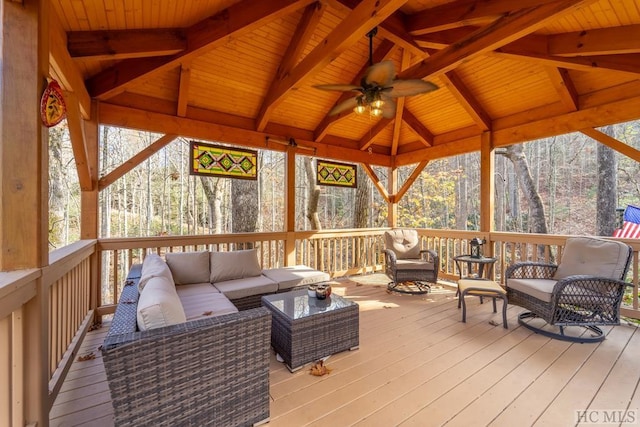 sunroom featuring ceiling fan, wood ceiling, and lofted ceiling with beams