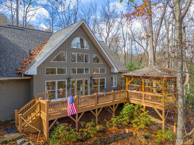 rear view of house with a gazebo and a deck