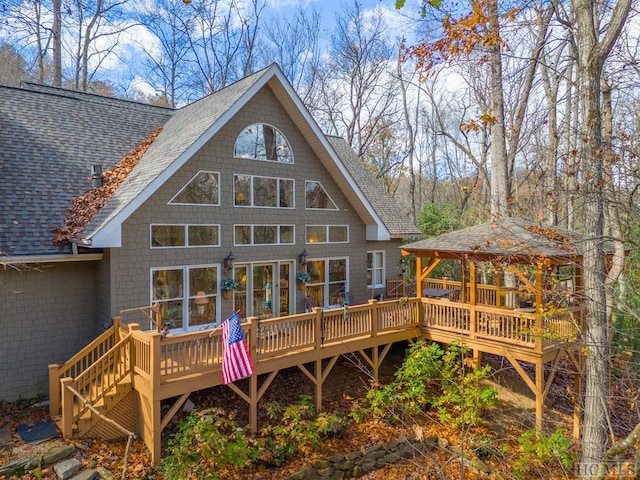 back of property with a deck and a gazebo