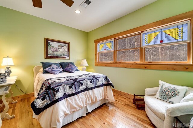 bedroom with hardwood / wood-style floors and ceiling fan