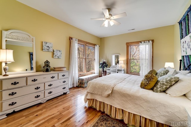 bedroom with ceiling fan and light hardwood / wood-style floors