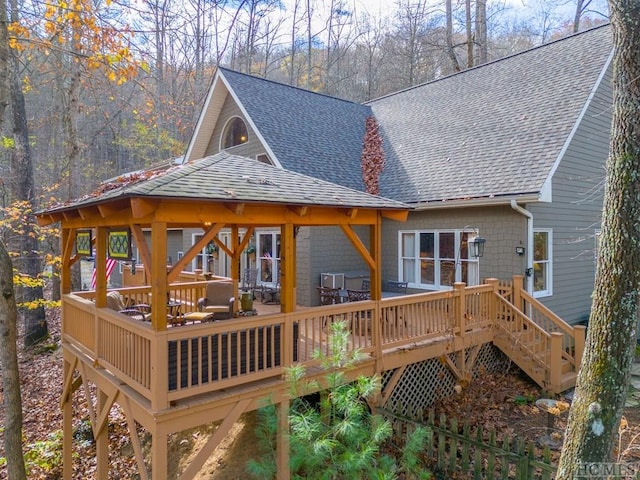 back of property with a wooden deck