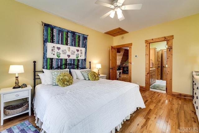 bedroom with ensuite bathroom, hardwood / wood-style floors, and ceiling fan