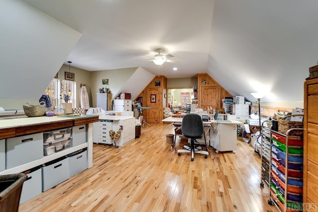 office featuring light hardwood / wood-style floors, lofted ceiling, and ceiling fan