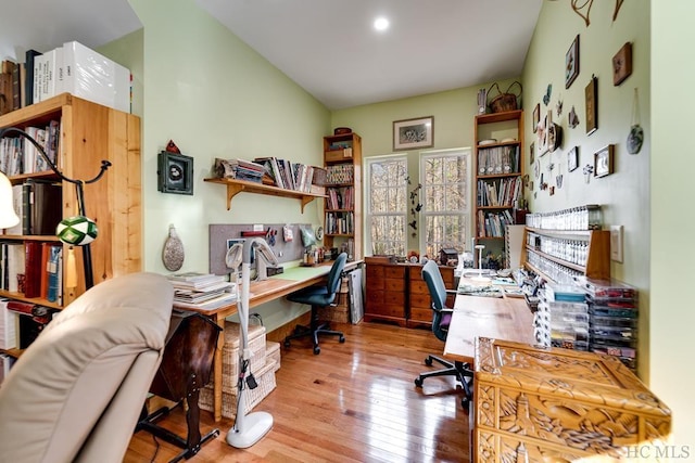 home office featuring light hardwood / wood-style flooring and vaulted ceiling