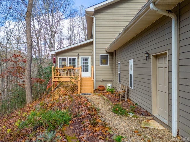 view of home's exterior with a wooden deck