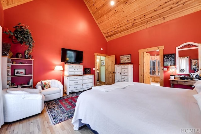 bedroom with high vaulted ceiling, light hardwood / wood-style flooring, and wood ceiling