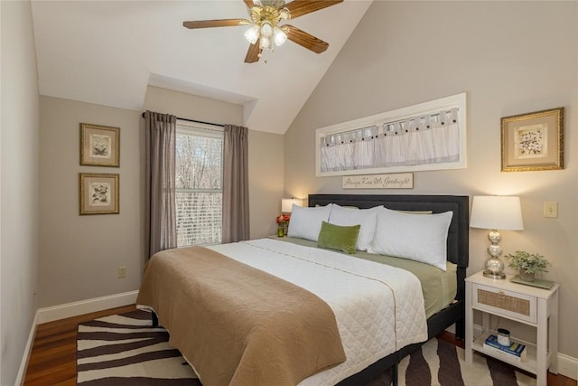 bedroom featuring baseboards, wood finished floors, lofted ceiling, and a ceiling fan