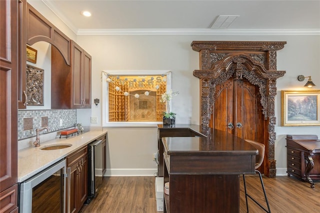 kitchen featuring wine cooler, a sink, dark wood-style floors, crown molding, and decorative backsplash