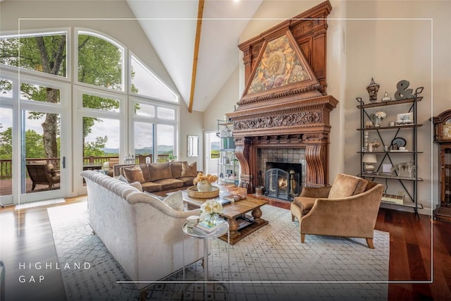 living room featuring wood finished floors, a fireplace, and high vaulted ceiling