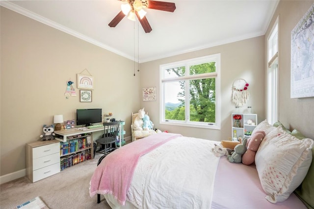 carpeted bedroom with ornamental molding, baseboards, and a ceiling fan