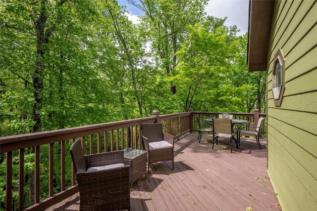 wooden terrace with outdoor dining area