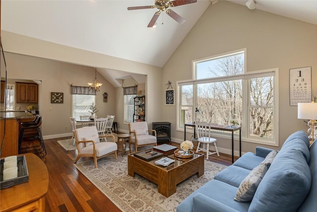 living room featuring high vaulted ceiling, ceiling fan, a chandelier, dark wood finished floors, and baseboards