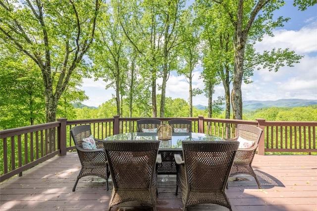 wooden terrace featuring outdoor dining space