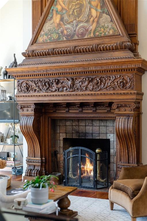 detailed view of a tiled fireplace and wood finished floors
