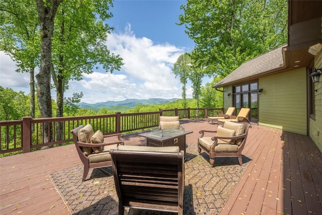 wooden deck featuring a mountain view and outdoor lounge area