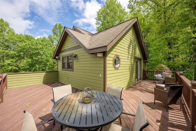 wooden terrace with outdoor dining area
