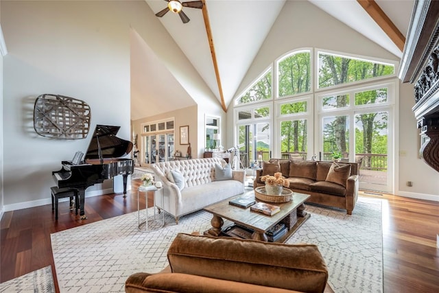 living room with a ceiling fan, high vaulted ceiling, baseboards, and wood finished floors