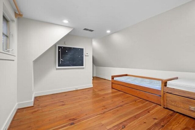 69 Old Cove Rd, Highlands, NC 28741 - unfurnished bedroom featuring recessed lighting, hardwood / wood-style flooring, vaulted ceiling, and baseboards