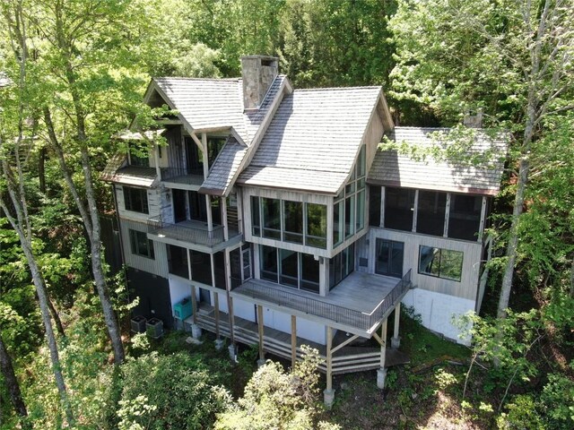 69 Old Cove Rd, Highlands, NC 28741 - rear view of house featuring a sunroom, a chimney, a forest view, and cooling unit