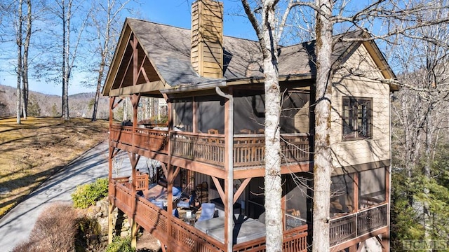 exterior space with a mountain view and a sunroom