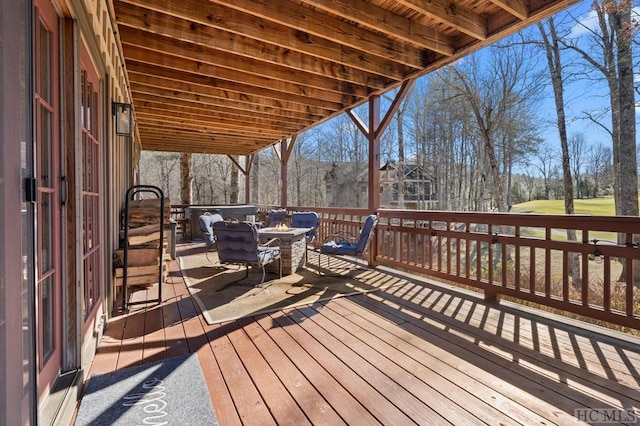 wooden terrace with an outdoor fire pit