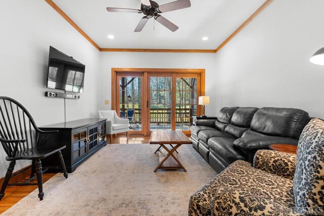 living room featuring ceiling fan, ornamental molding, and hardwood / wood-style floors