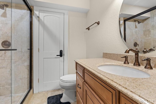 bathroom featuring an enclosed shower, vanity, and toilet