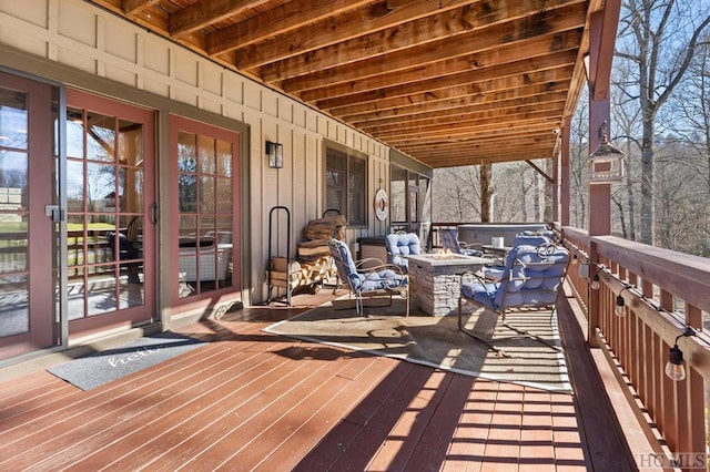 wooden terrace featuring a fire pit