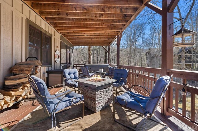 wooden deck with an outdoor fire pit