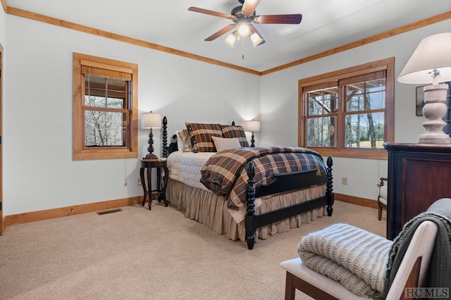 bedroom featuring ceiling fan, crown molding, and light colored carpet