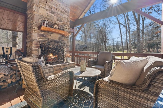 deck with an outdoor stone fireplace