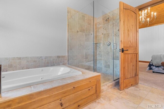 bathroom with a notable chandelier and a shower with shower door