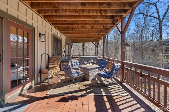 wooden terrace with an outdoor fire pit