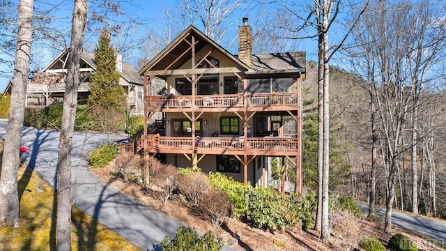 back of house with a wooden deck