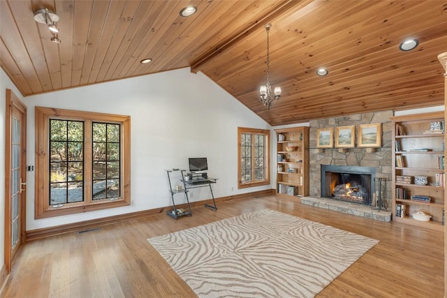 living room featuring vaulted ceiling with beams, hardwood / wood-style flooring, a stone fireplace, and wooden ceiling