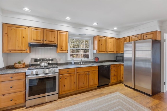 kitchen featuring light hardwood / wood-style floors, sink, and black appliances