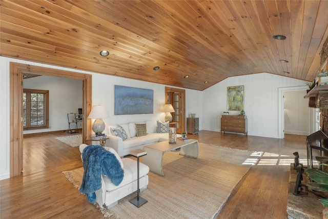 living room featuring lofted ceiling, light hardwood / wood-style flooring, and wooden ceiling