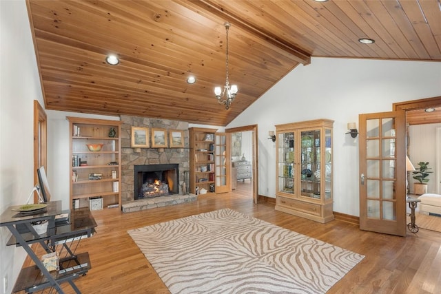 living room featuring french doors, beam ceiling, wood ceiling, wood-type flooring, and a fireplace