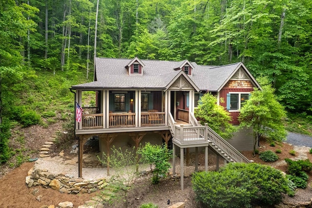 45 Boulder Creek Ln, Tuckasegee, NC 28783 - chalet / cabin with stairs, a forest view, a shingled roof, and covered porch